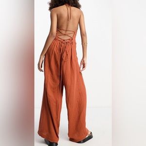 ASOS DESIGN crinkle frill halterneck jumpsuit with wide leg in rust